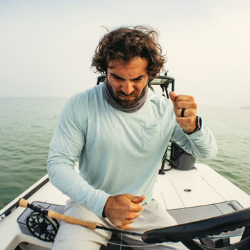 man on boat wearing sea grass hoodie