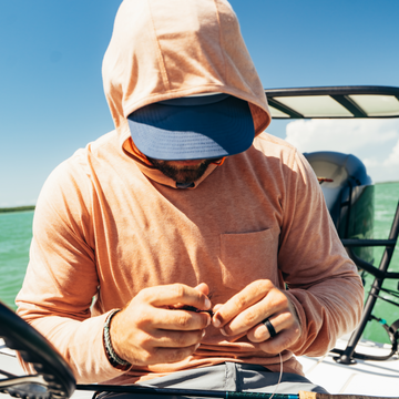 man on boat wearing sunset hoodie