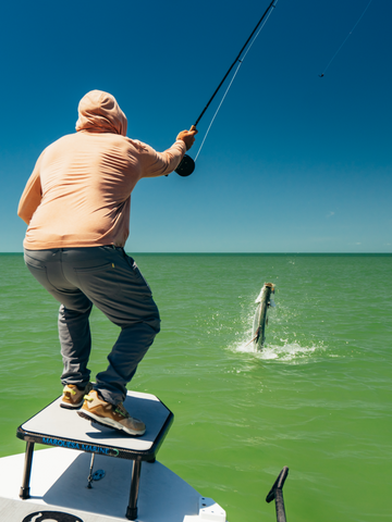 man catching fish wearing sunset hoodie