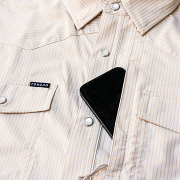 closeup of phone going into chest pocket