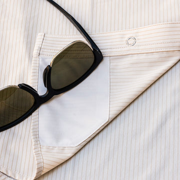 closeup of glasses cleaner of tan striped shirt