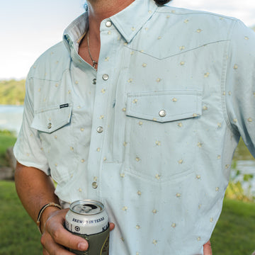 closeup of man wearing blue floral short sleeve shirt
