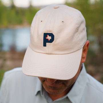 man wearing poncho P hat