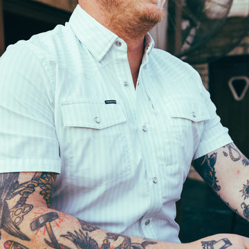 Man wearing striped pearl snap short sleeve shirt