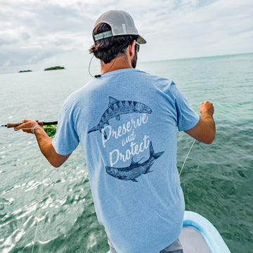 Man fishing on boat with tarpon and bonefish t-shirt on