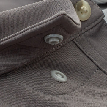 Close up of snap collar on grey button down fishing shirt