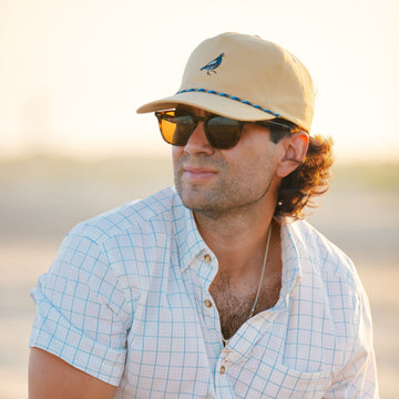 man wearing quail hat