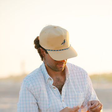 man wearing quail hat