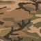 Olive green, tan, and dark brown camouflage pattern with organic shapes and branch-like elements.