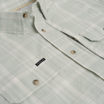 Flat lay product photo of green fishing shirt pockets
