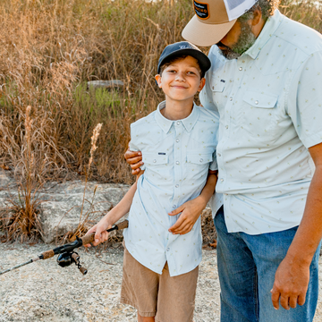 man and son wearing the same button down pearl snap shirt
