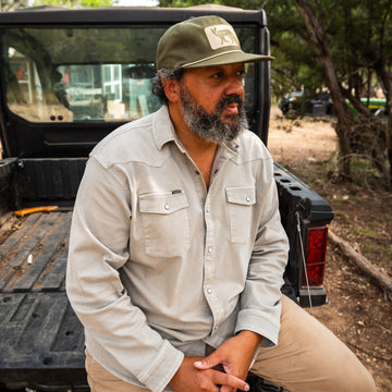 man sitting on utv wearing the stockton denim shirt