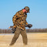 man carrying waterfowl decoys in old school camo flannel