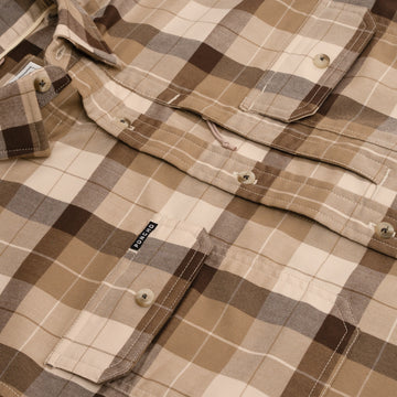 Close up photo of brown plaid flannel button down shirt