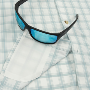 Closeup of sunglasses with lens cleaner on shirt