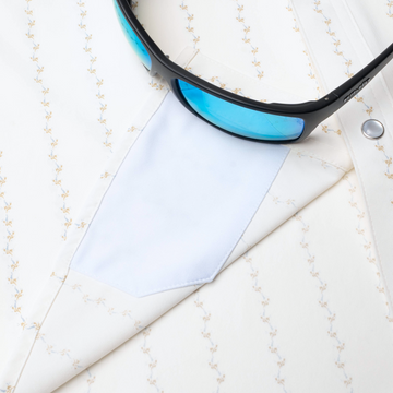 sunglasses with lens cleaner on shirt