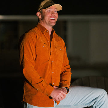 man with one leg up wearing the 1963 corduroy shirt