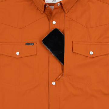 Phone in chest zipper pocket of shirt