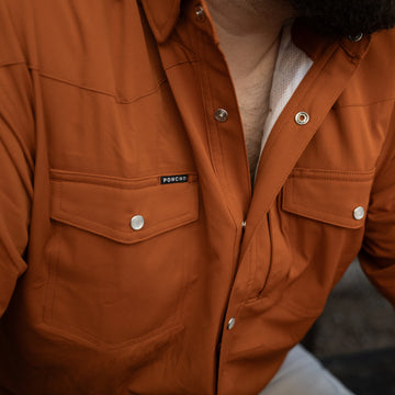 Close-up of a rust-colored shirt with snap buttons and chest pockets from The 1969 collection