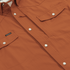 Close-up of The 2005 shirt in rust color with snap buttons and front chest pockets by Poncho Outdoors