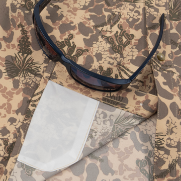 Closeup of sunglasses with lens cleaner on shirt