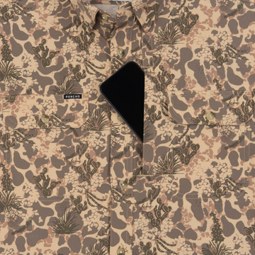 Phone in chest zipper pocket of shirt