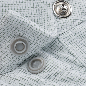 The Alpine shirt in textured white fabric with silver and gray buttons close up