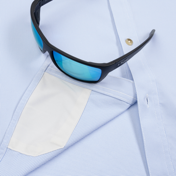 Closeup of sunglasses with lens cleaner on shirt