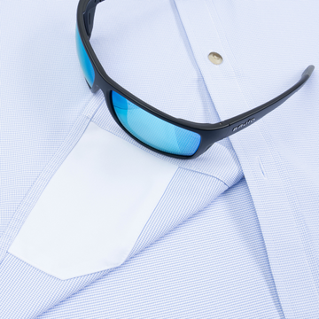 Closeup of sunglasses with lens cleaner on shirt
