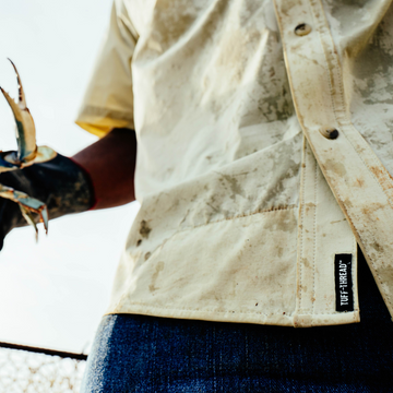 man wearing tan short sleeve shirt closeup of tuff-thread patch