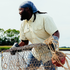 man holding cage wearing tan short sleeve shirt