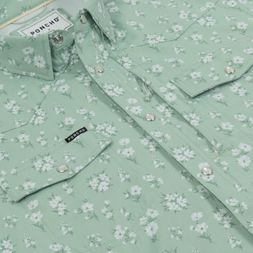 Close-up of a light green floral shirt with button snaps and pockets from The Bat Masterson collection by Poncho Outdoors.