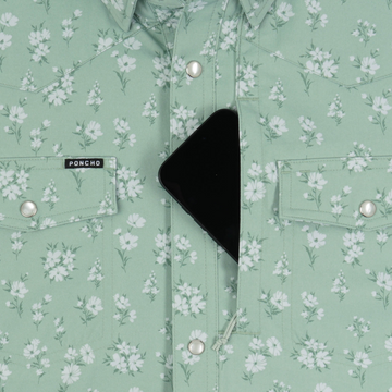 Close-up of a mint green floral shirt by Poncho Outdoors with buttoned pockets and a phone partially tucked inside, The Bat Masterson.