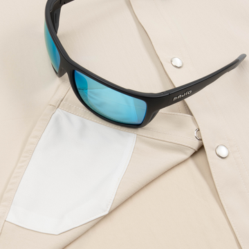 Closeup of sunglasses with lens cleaner on shirt