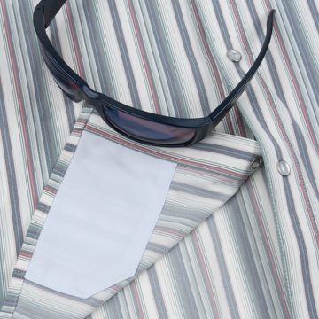 Closeup of sunglasses with lens cleaner on shirt