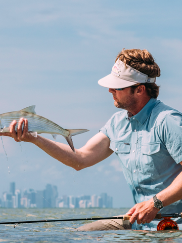 man holding fish wearing the biscayne shirt