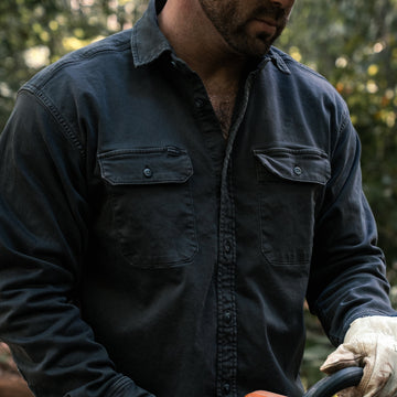 The Blacksburg dark long sleeve shirt worn outdoors among trees