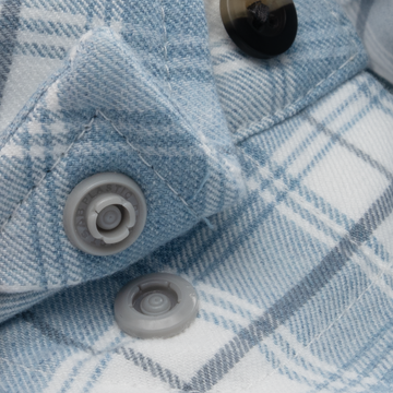 Close-up of light blue and white plaid fabric with buttons on The Blue Bison shirt showing detailed stitching.