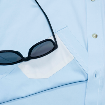sunglasses with lens cleaner on shirt
