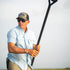 Man wearing Blue Steel light blue shirt and sunglasses holding a paddle outdoors on a bright day
