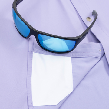 Closeup of sunglasses with lens cleaner on shirt