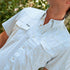 The Bonito light blue patterned button shirt worn outdoors among leafy greenery