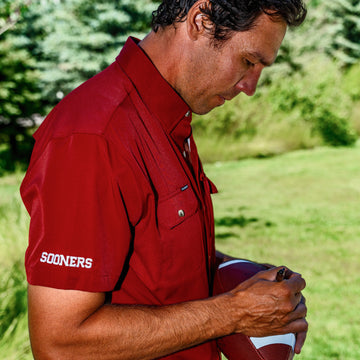 man singing football wearing red OU shirt