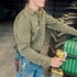 The Buck Snort olive work shirt worn while repairing a tractor with a power drill