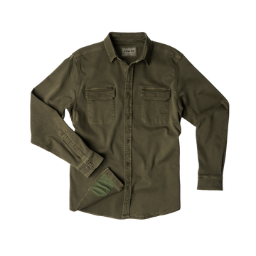 The Buck Snort olive green outdoor shirt with buttoned chest pockets and long sleeves laid flat.