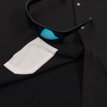 Closeup of sunglasses with lens cleaner on shirt