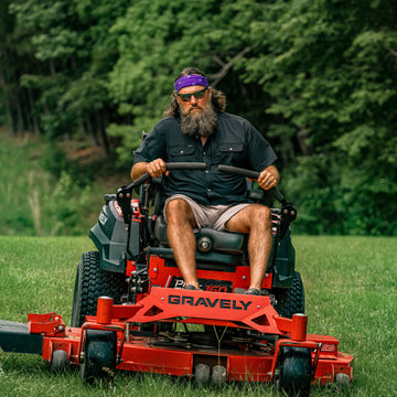 man riding lawn mower wearing the burnt end shirt