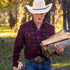 man holding firewood wearing the casper flannel shirt