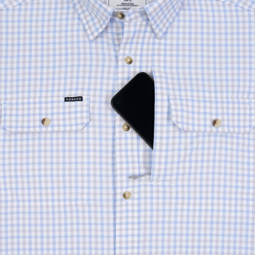 Phone in chest zipper pocket of shirt