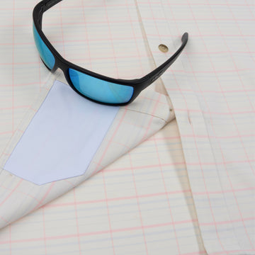 Closeup of sunglasses with lens cleaner on shirt